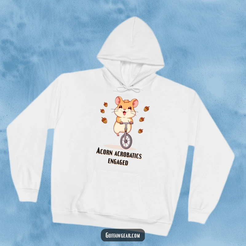 Funny Hamster Hoodie: A hamster masterfully rides a unicycle while juggling acorns, designed for cozy amusement.